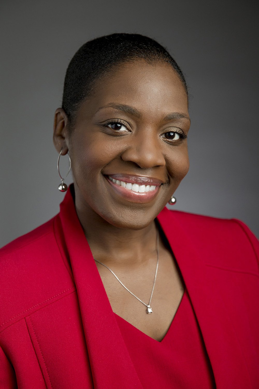 african american female executive headshot on grey.JPG