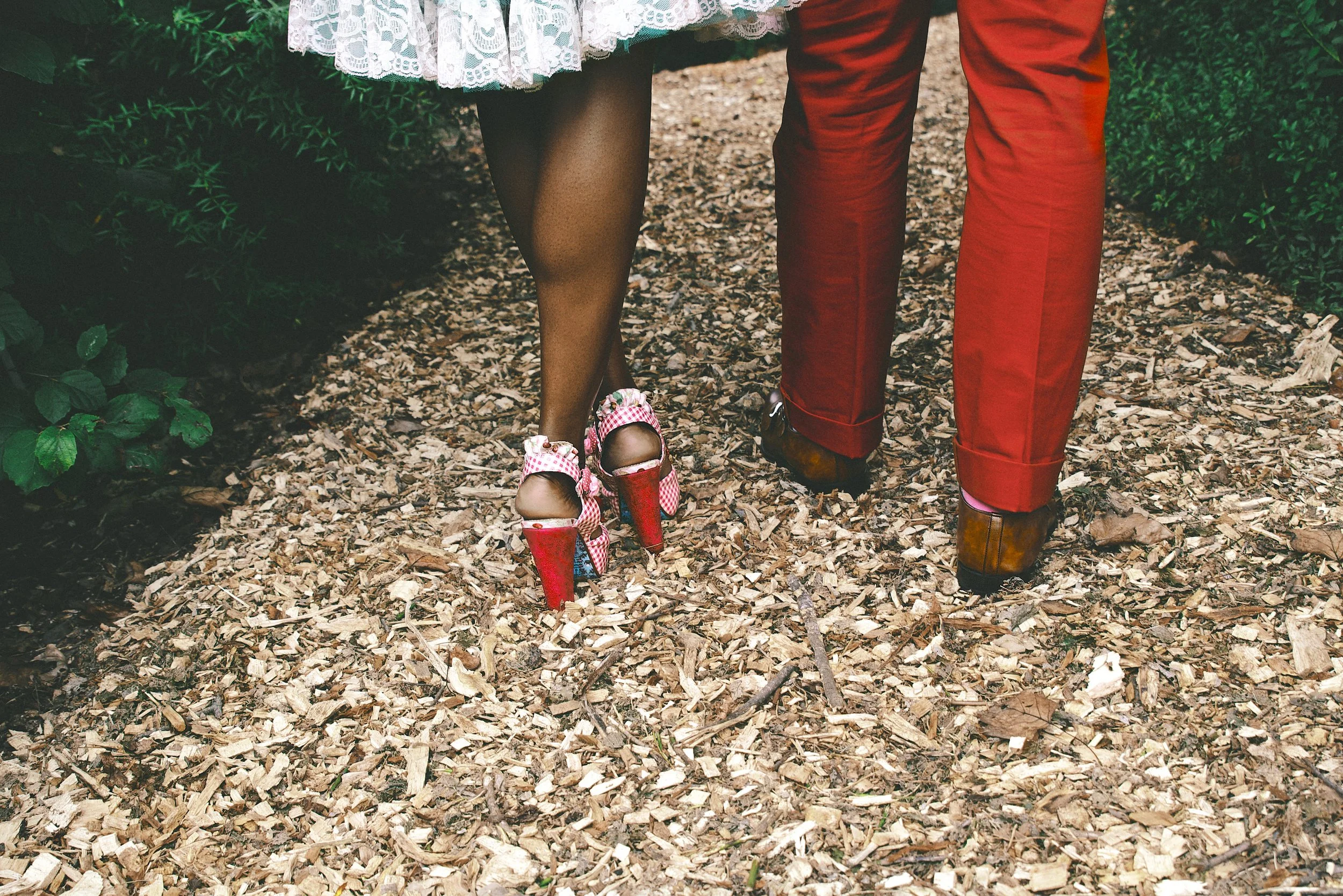 A couple walking together along a garden path, reflecting collaboration, creativity, and the thoughtful approach behind Ascots & Pearls.jpg