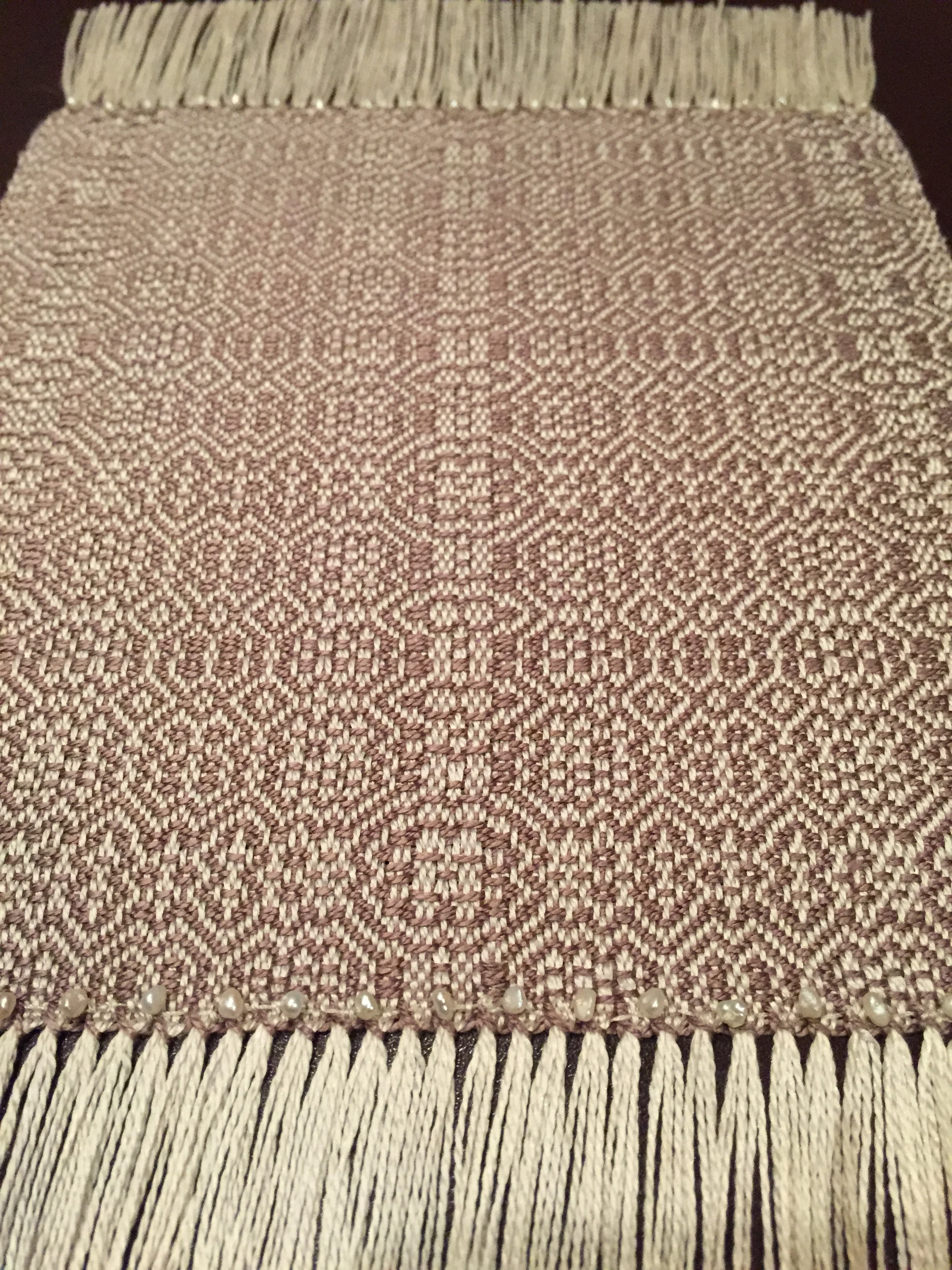 Custom silk weaving in pattern made by using the names of the bride and groom