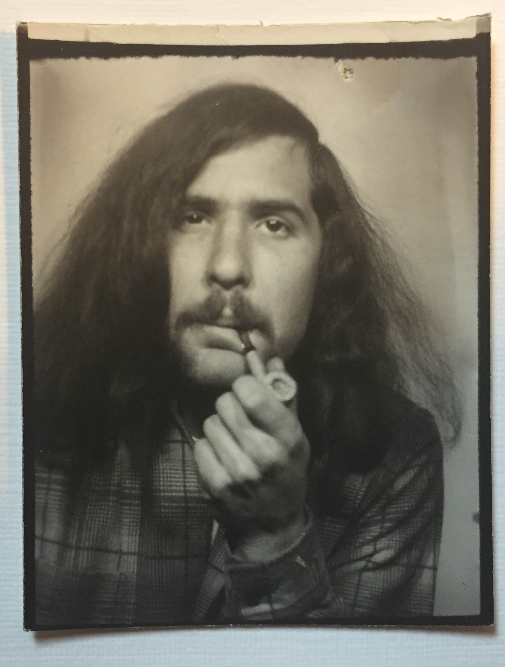 A section of a photo booth strip featuring my father and a pipe (c. 1975).