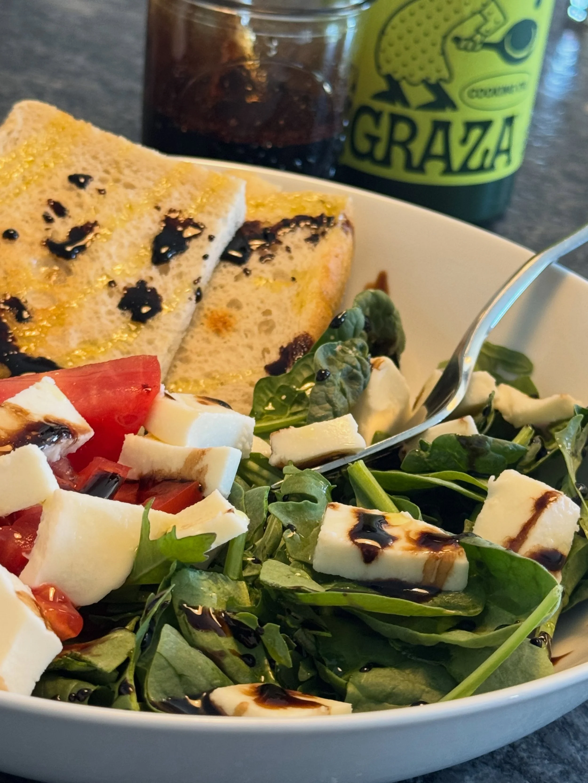 Summer flavor is here! 🍅🥬🧀

Fresh mozzarella &amp; tomatoes from @harensmarket 
Arugula &amp; sourdough 
Homemade balsamic glaze &amp; @getgraza olive oil
Salt &amp; pepper