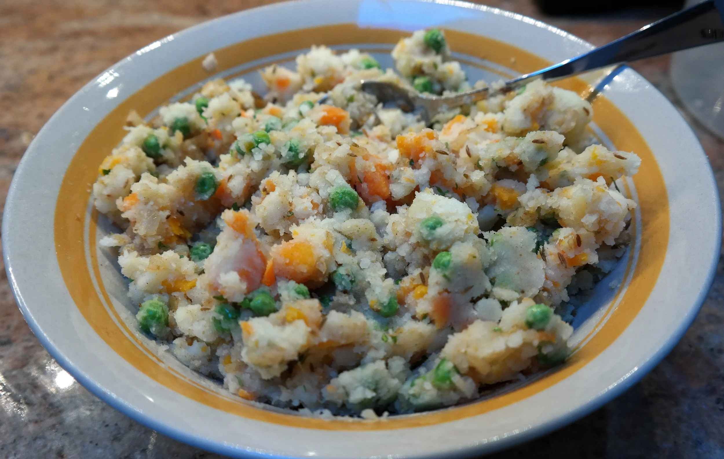 Added ingredients to the cooked and coarsely mashed potato and carrot to make the filling