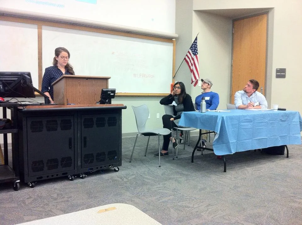 Yael Lazar presents on "digital darshan" as Bhakti Mamtora, Nick Collins, and Dr. Phillip Green look on. 