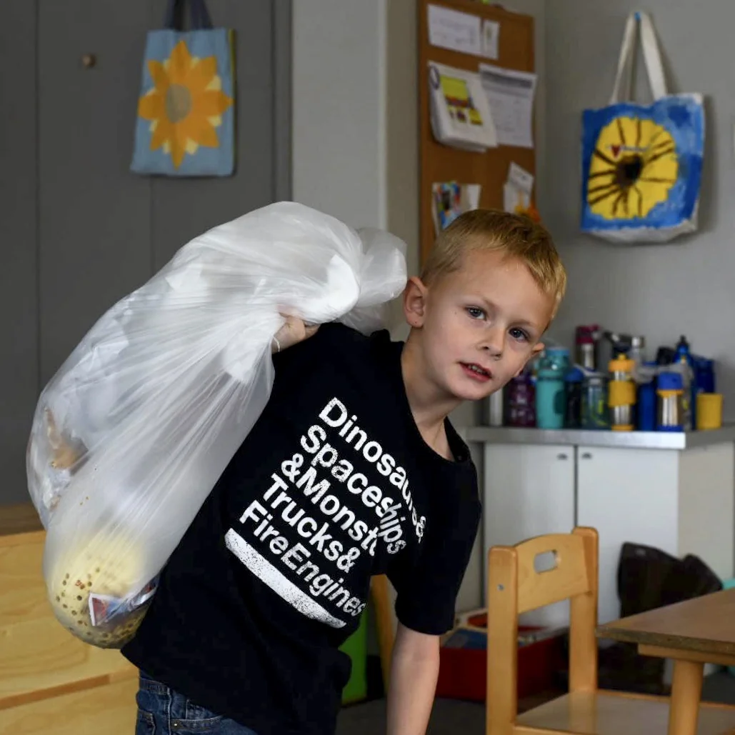 Luke doing trash duty at Montessori...