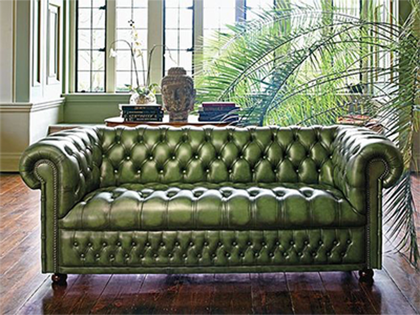 Green leather Chesterfield couch already installed in the living room
