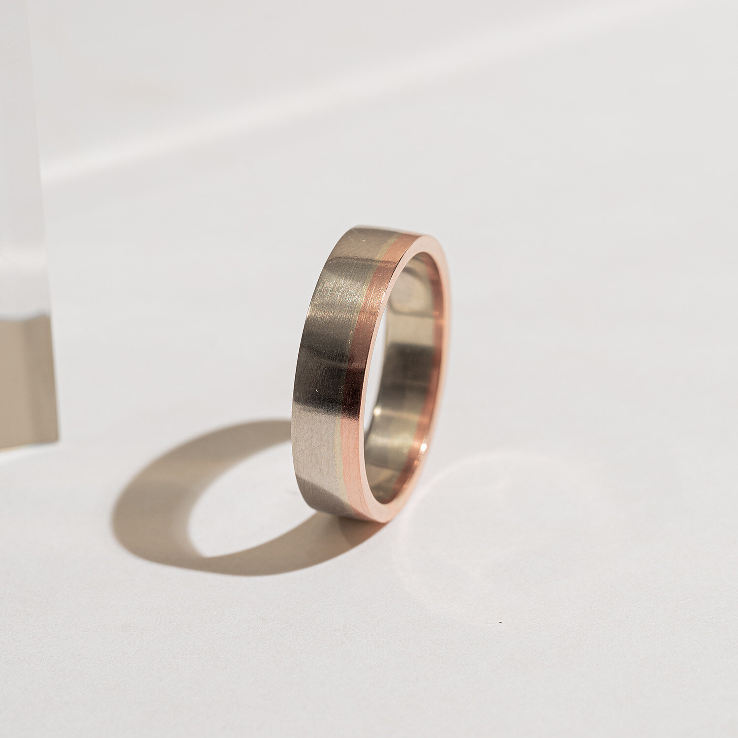 White gold band with rose gold edge
