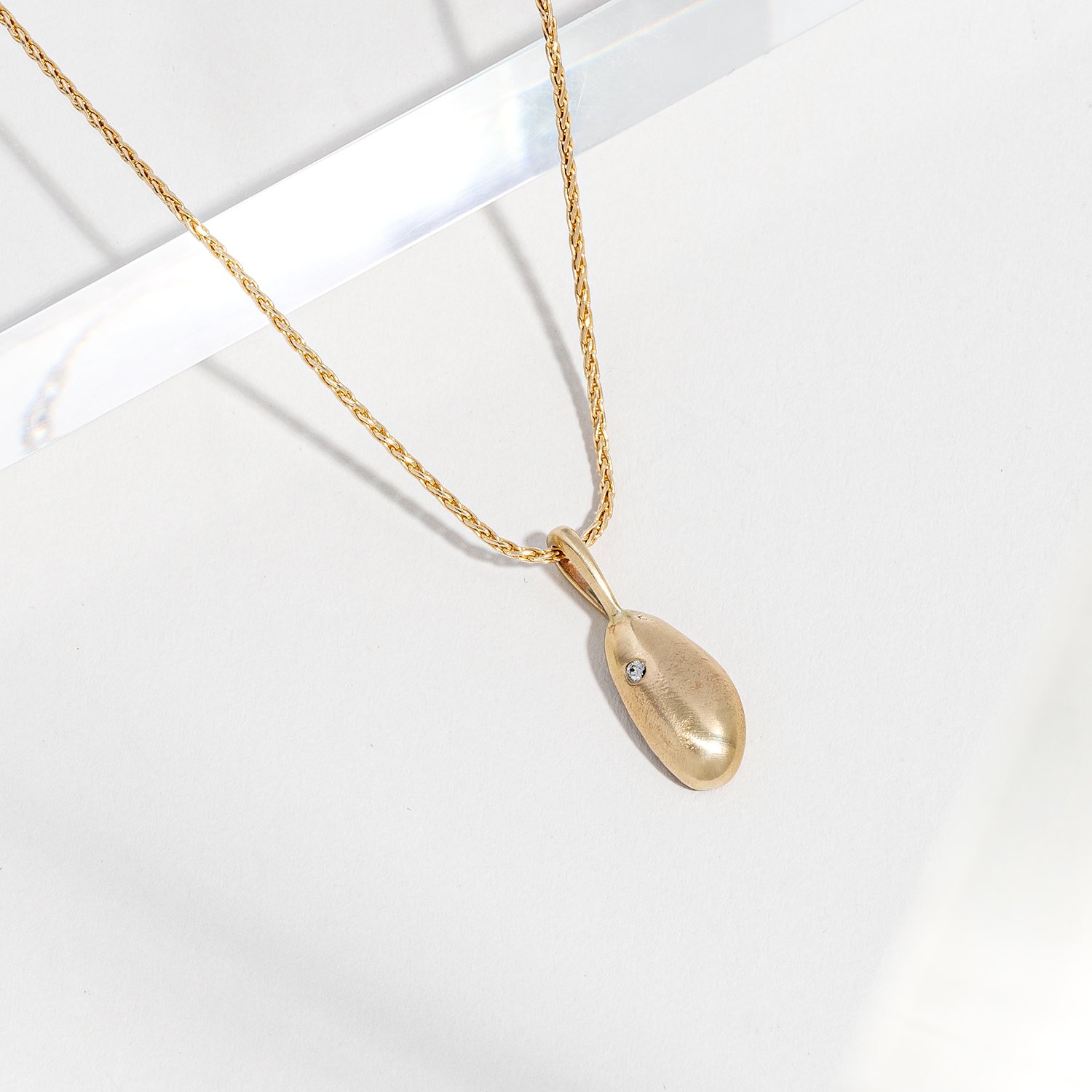 Organic gold and diamond pendant on chain.  