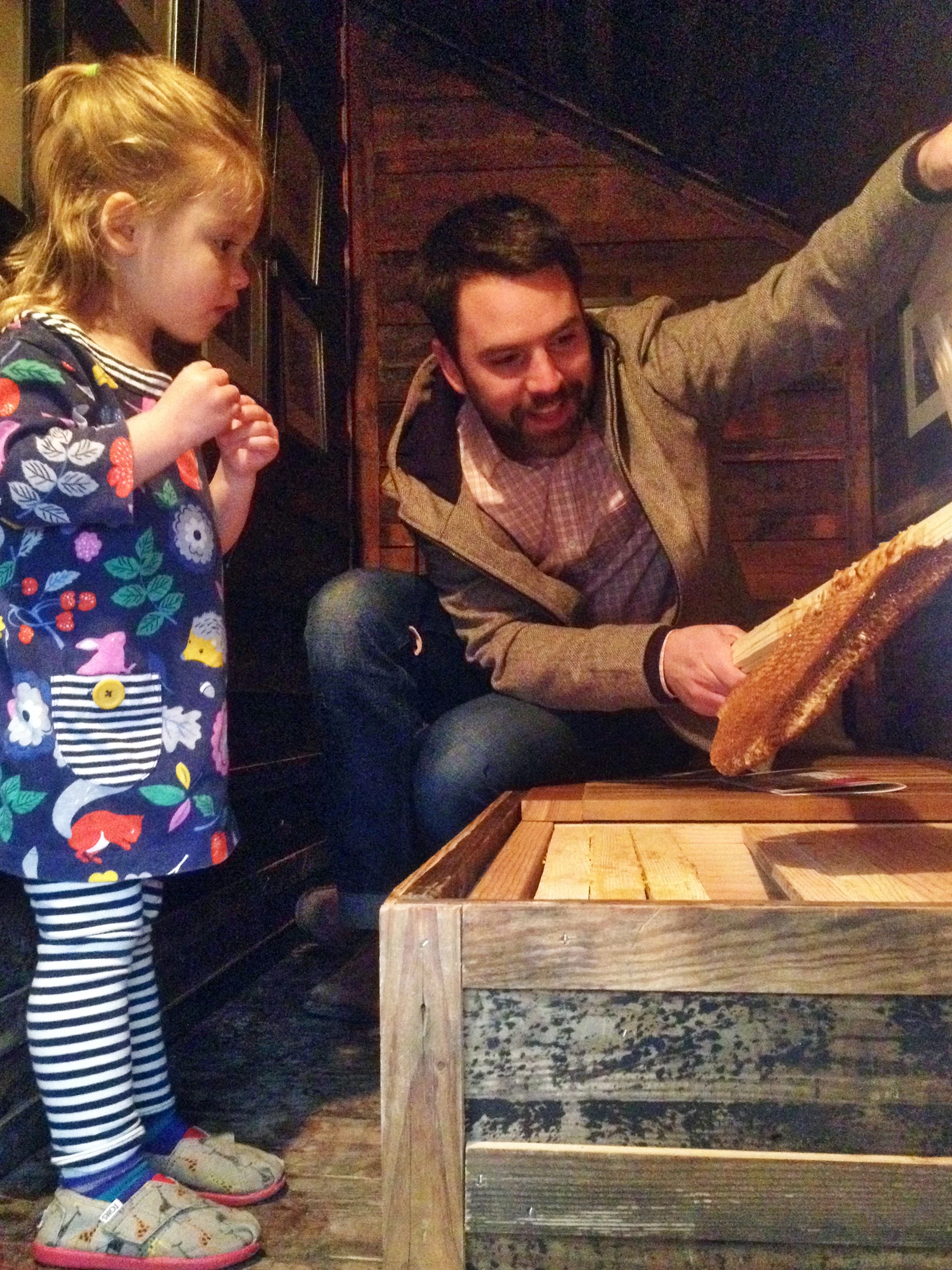 A father explaining honeybee society to his daughter.