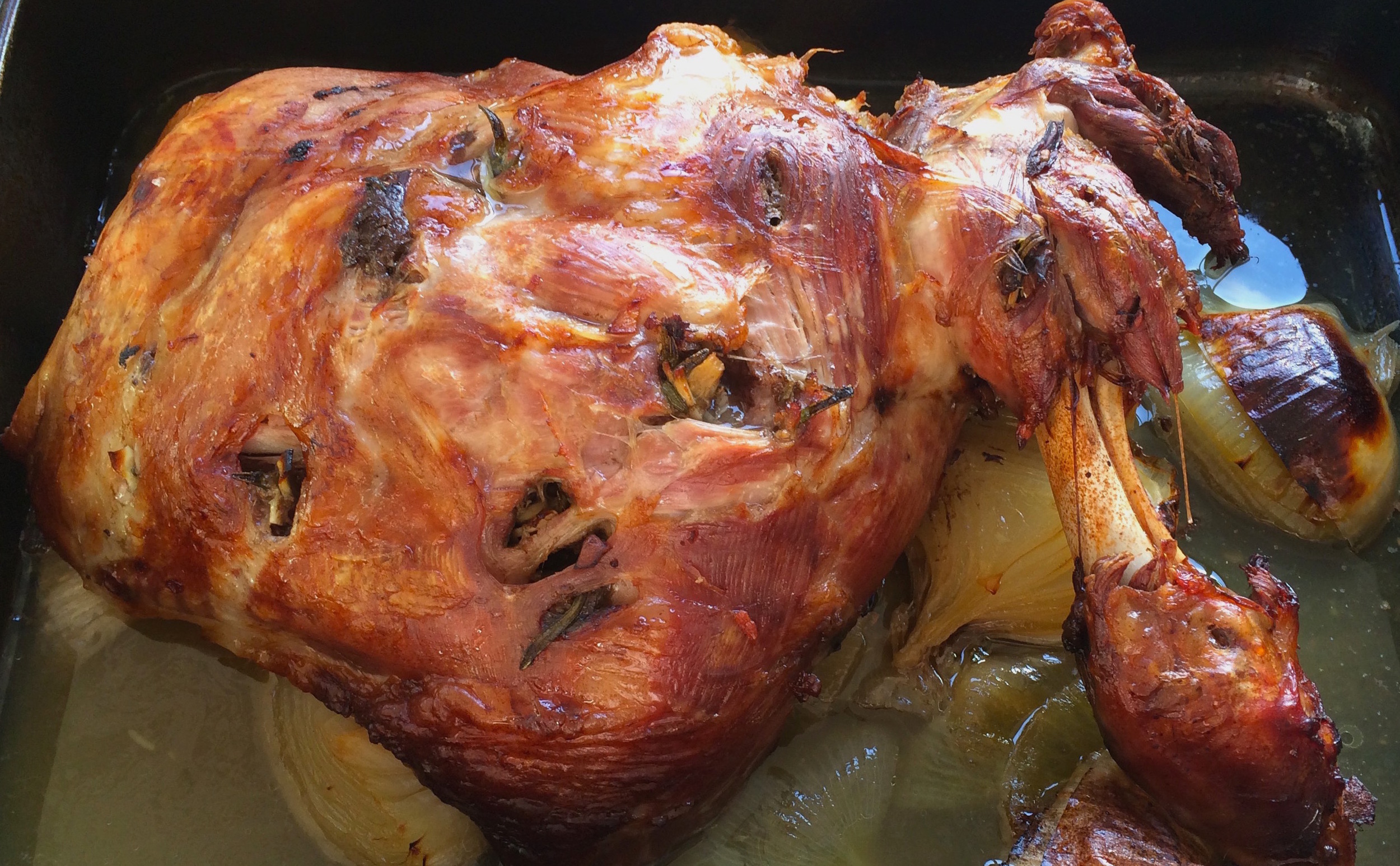 Slow-roasted lamb shoulder studded with anchovy, garlic and rosemary