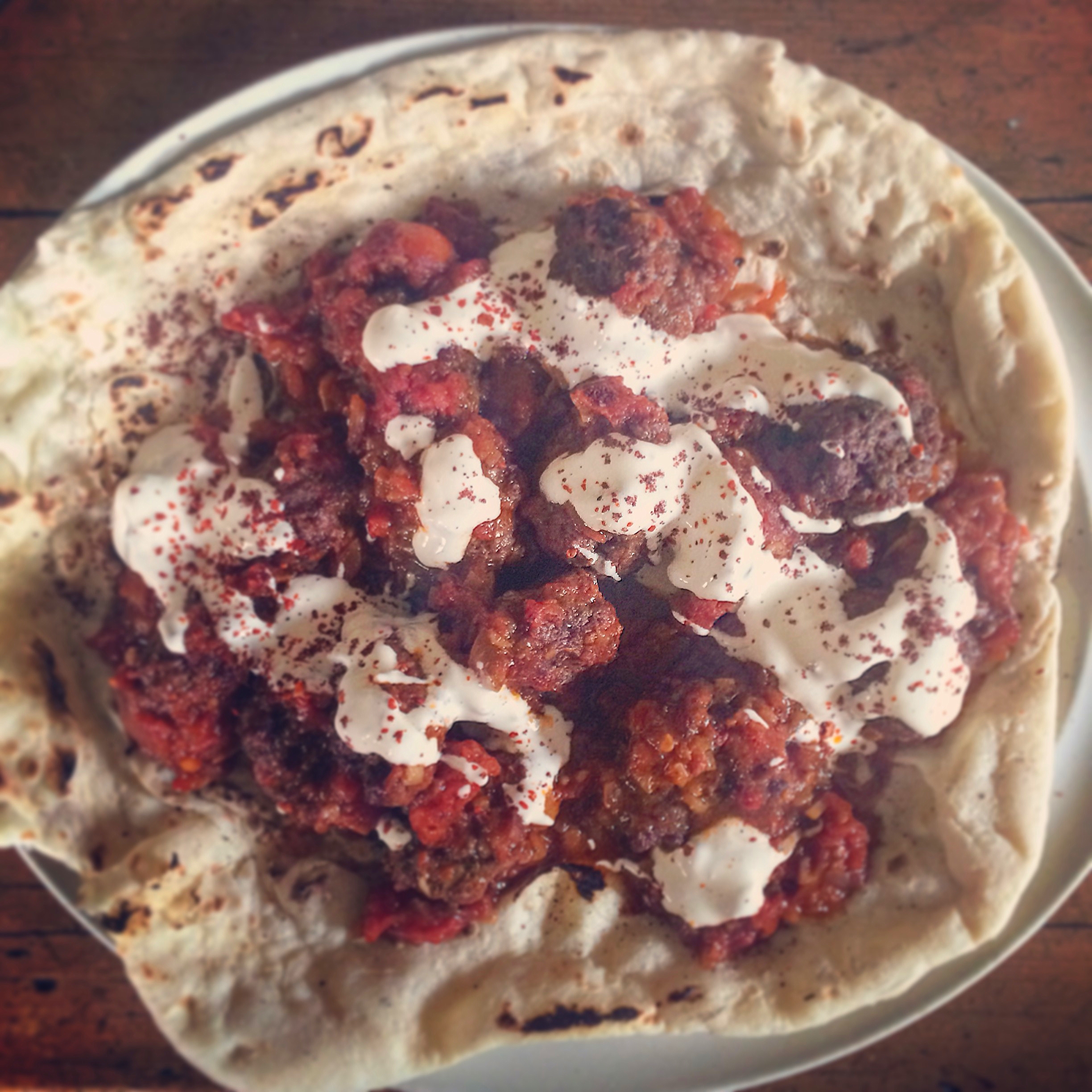 Kofte kebab with spiced tomato sauce and yoghurt
