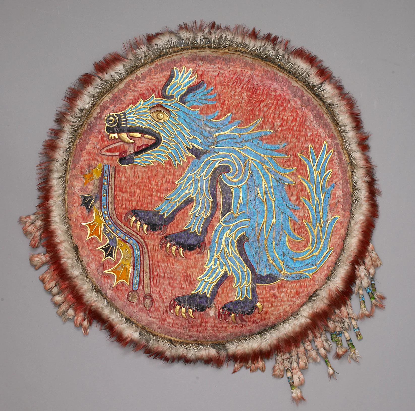 Coyote Shield. Feathers, gold, cotton, leather, pigments, reeds. Early 16th c. 34.5 cm (radius). Acc. no. 43,380. Weltmuseum, Vienna