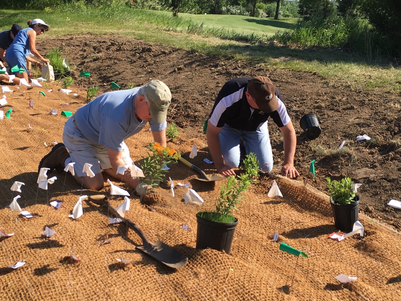 Steve Roe, left, is a Lake Panorama resident and Guthrie County Soil and Water Conservation District Commissioner. He and Brad Halterman, LPA project manager, helped plant the rain garden June 10.