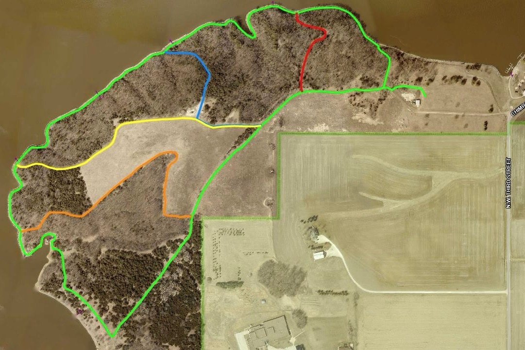 This aerial view of the south shore shows the various segments of the Lake Panorama trail system. The green trail is the largest loop, with the red, blue, yellow and orange trails offering a variety of distances and views.