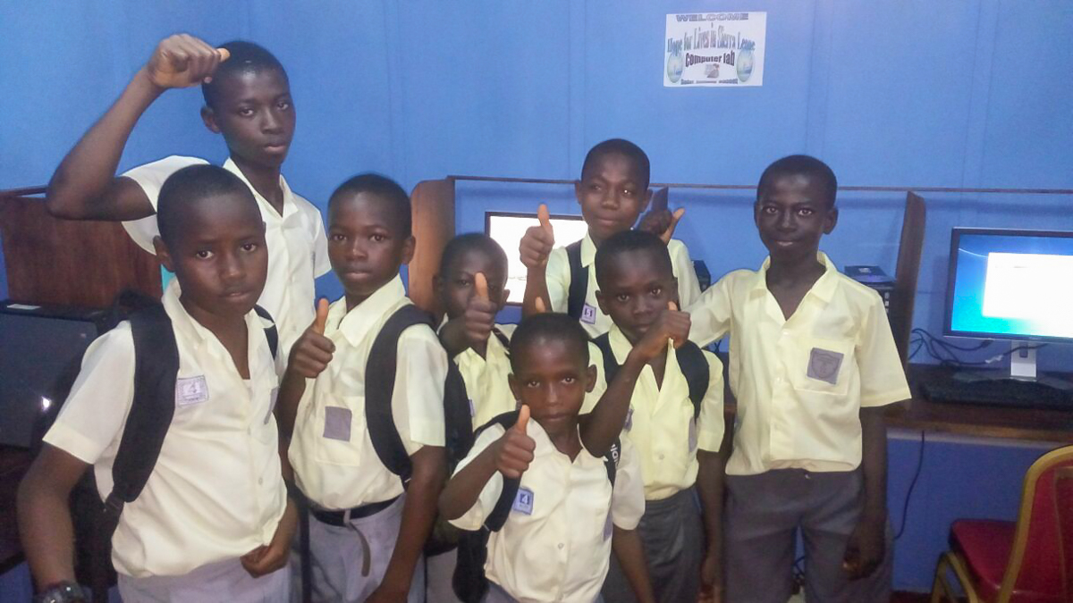 School kids giving their thumbs-up for the new computer lab