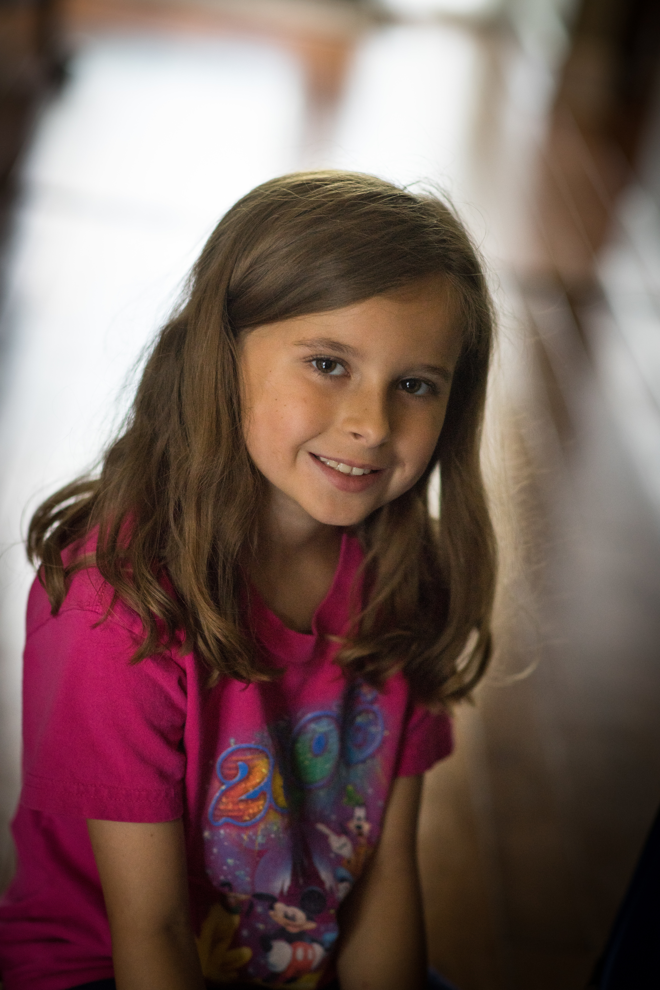 The Minolta 85mm Prime f1.4 produces agreeable candids. I think it is a function of the 85mm focal length related to the largest aperture. Usually the parts of your subject that you want to be in focus, just are and those things that are ancillary to the shot, fade away nicely.