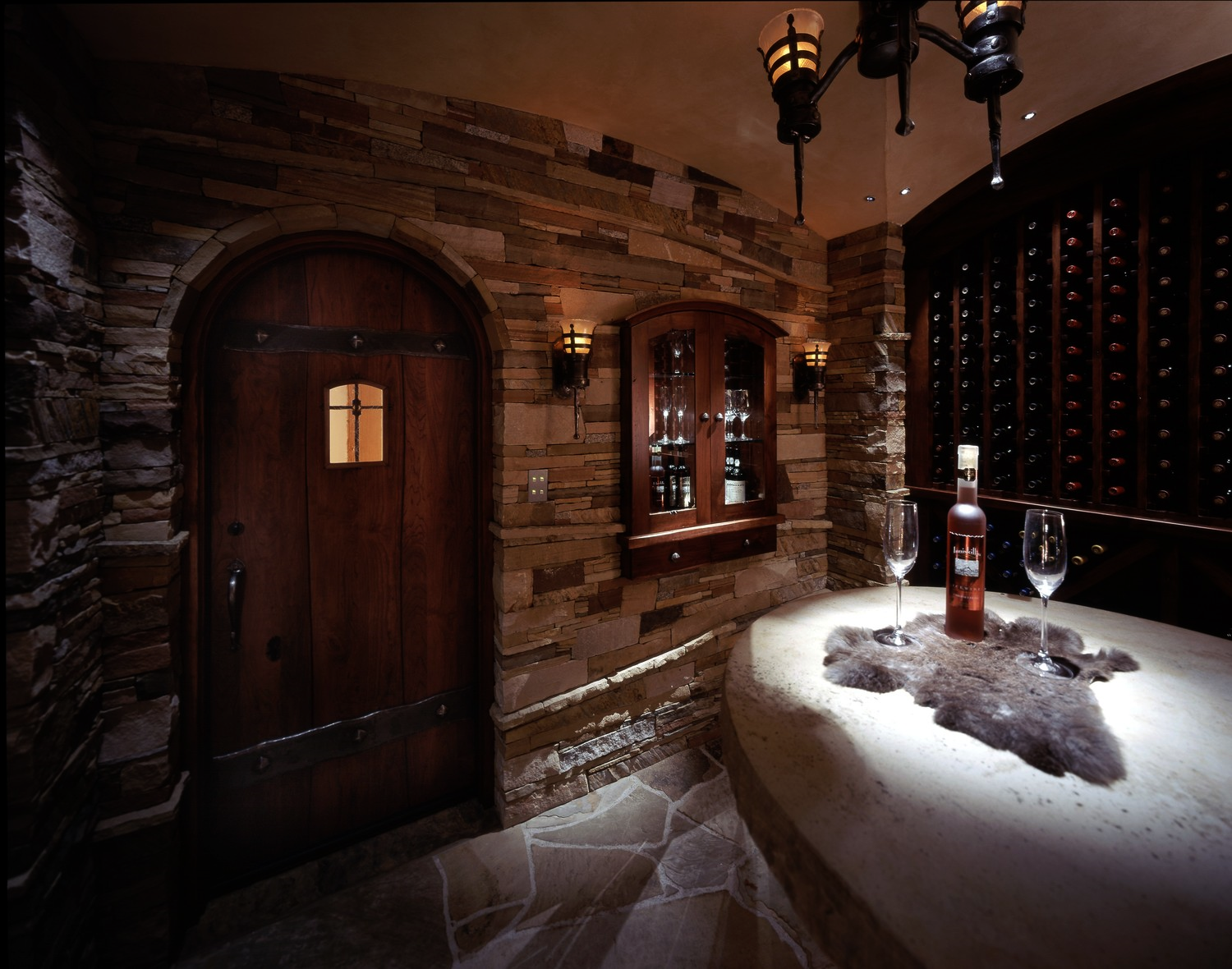 Damien Cellar. Hand crafted fiber optic "flame" sconces flank the internally Illuminated dessert wine cabinet while perfectly tuned white light Illuminates the tasting table. 