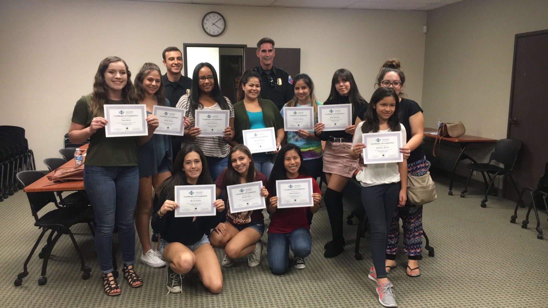 Some students show off their CPR certification.