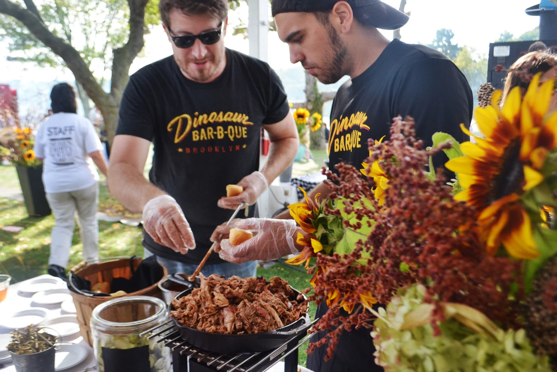 The fellas from Dinosaur BBQ serving up their pulled pork sliders at the Grill Master party