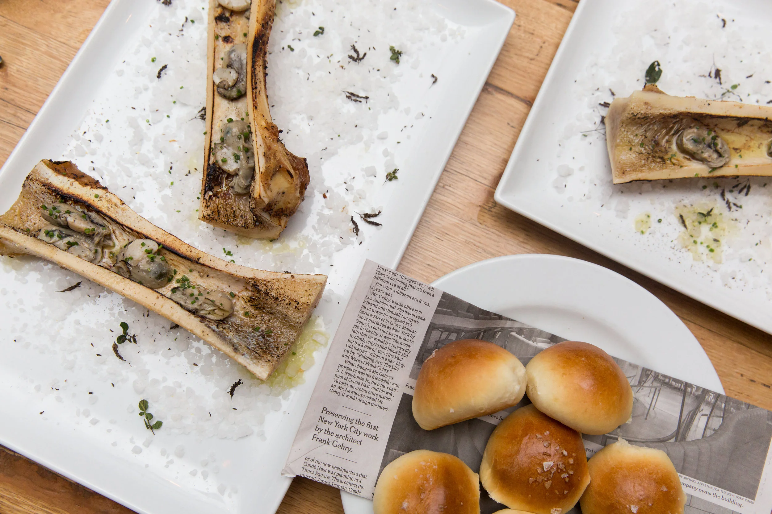 Oyster Served In Marrow Shells And Parker House Rolls at The Whelk