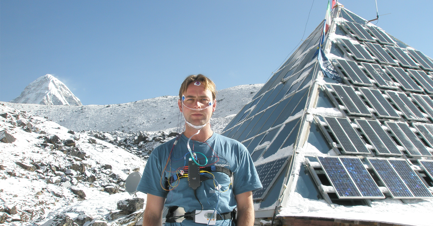 Andrew outside The Pyramid, a high altitude research laboratory located near Mt Everest in Nepal, wired up with electrodes after an overnight sleep study. Summit of Pumori visible in background.
