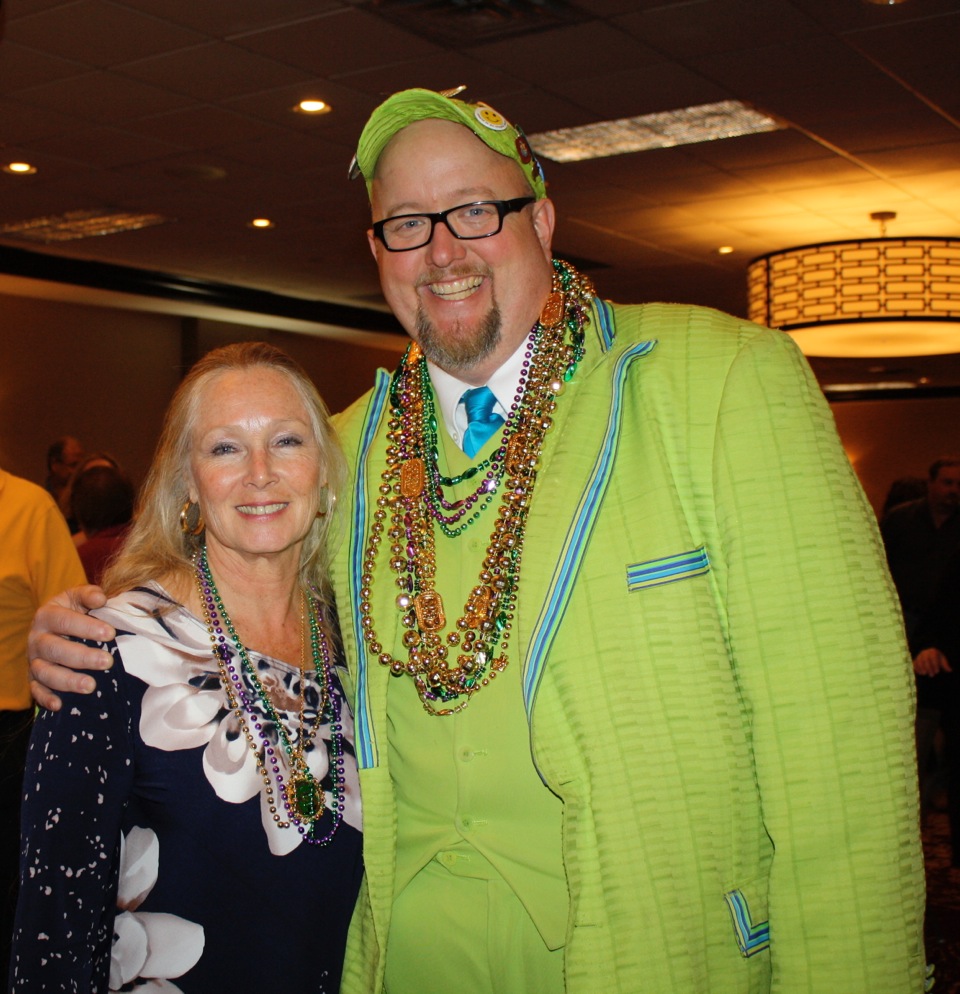 Emcee Shannon Thomason and JA Life Member Suzanne Newkirk ham it up at Junior Auxiliary Mardi Gras Trivia Night