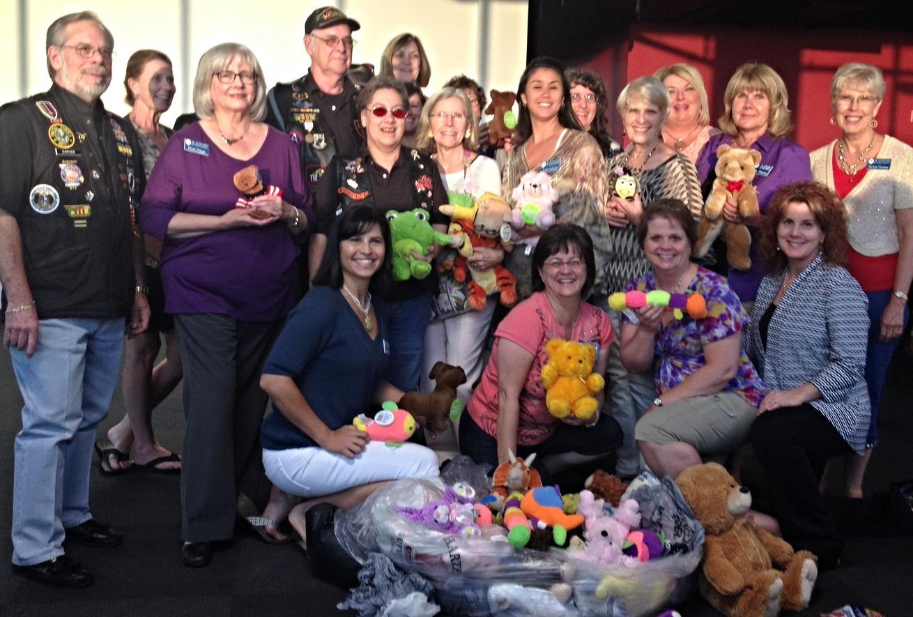 JATC members surround Ron Simmons, President of The Vietnam Veterans of America, Chapter 913, Bob Sarver, Public Relations Chairman of The Vietnam Veterans of America, Chapter 913, and Lois Simmons after they deliver new stuffed animals to JATC to use in their Tender Critters Project.