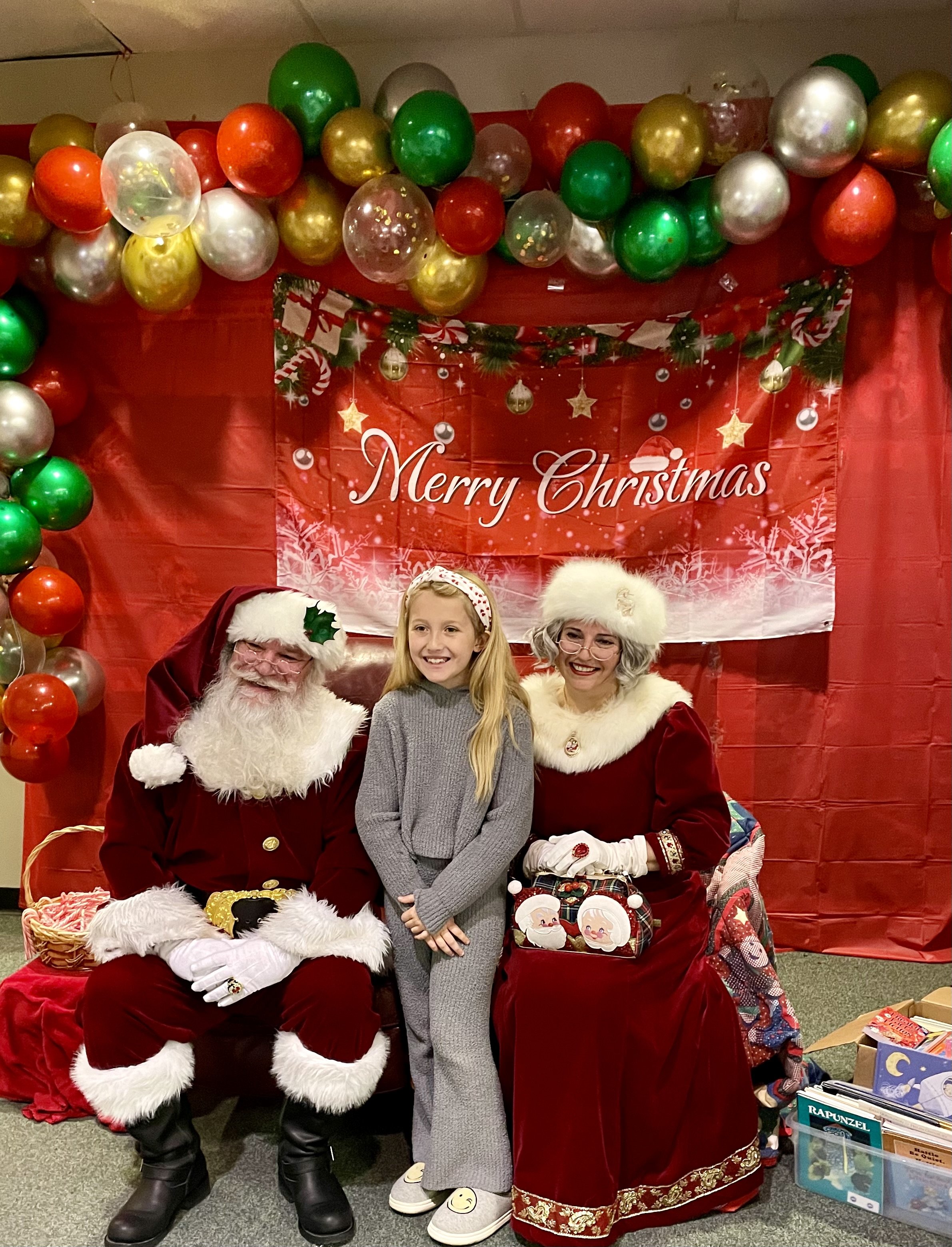 Grace Harrison with Santa and Mrs. Claus.jpg