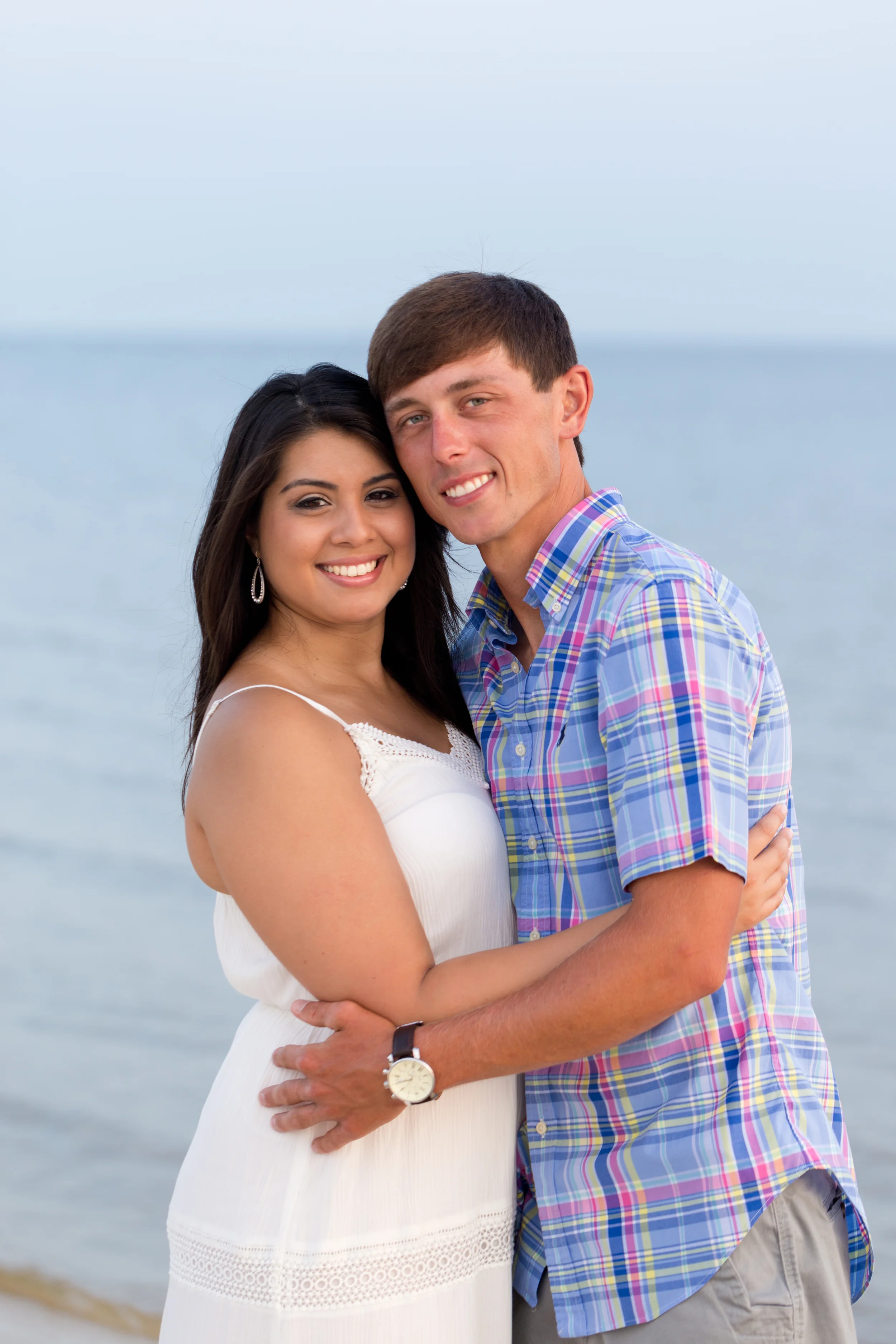 gorgeous couple smiling on beach (engagement photo on Mississippi Gulf Coast)