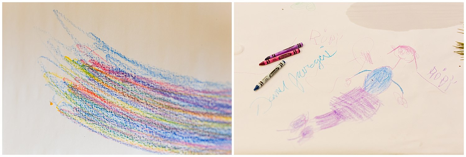 kids' drawings with crayons on paper tablecloth 