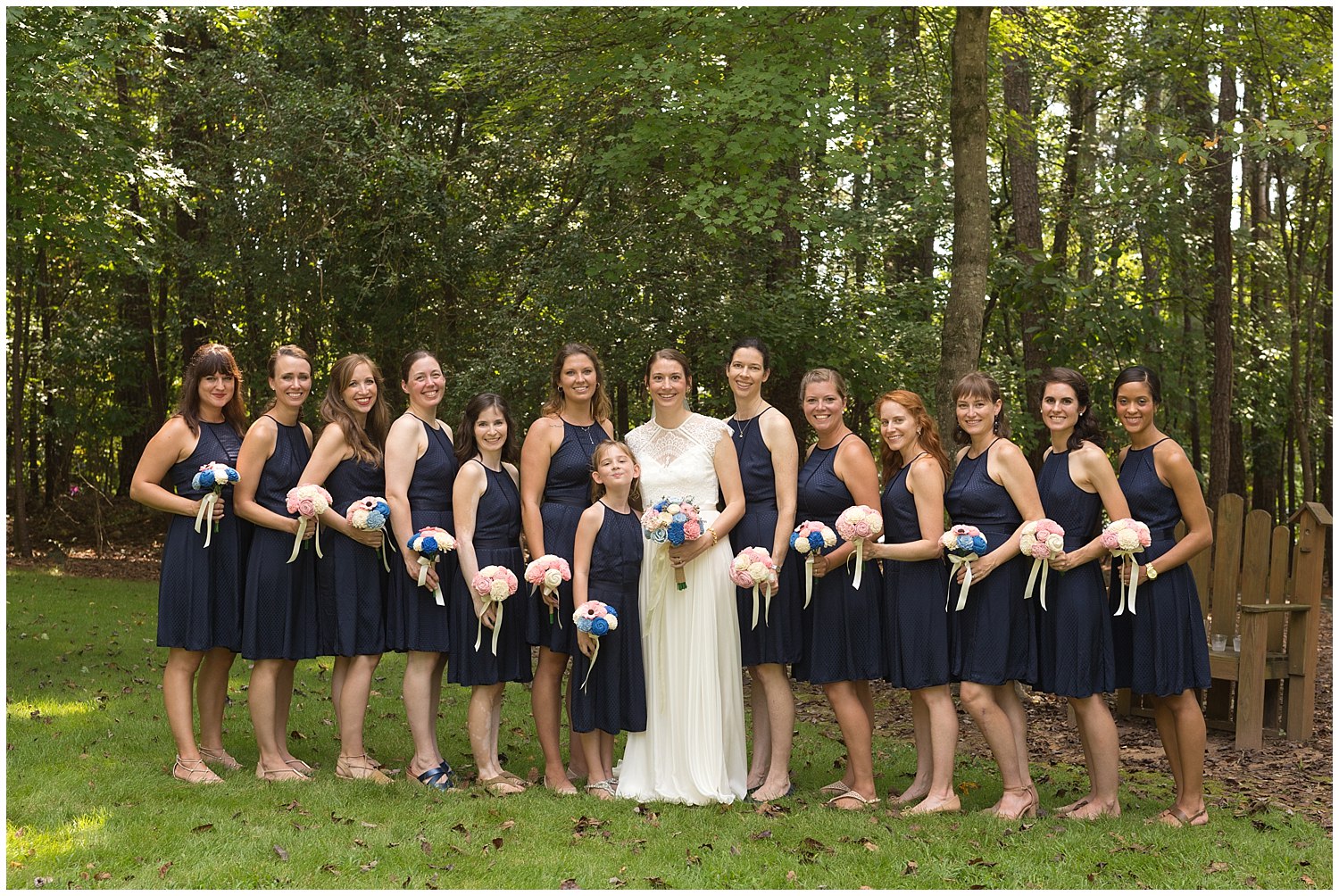 bridesmaids with navy blue dresses and pink bouquets