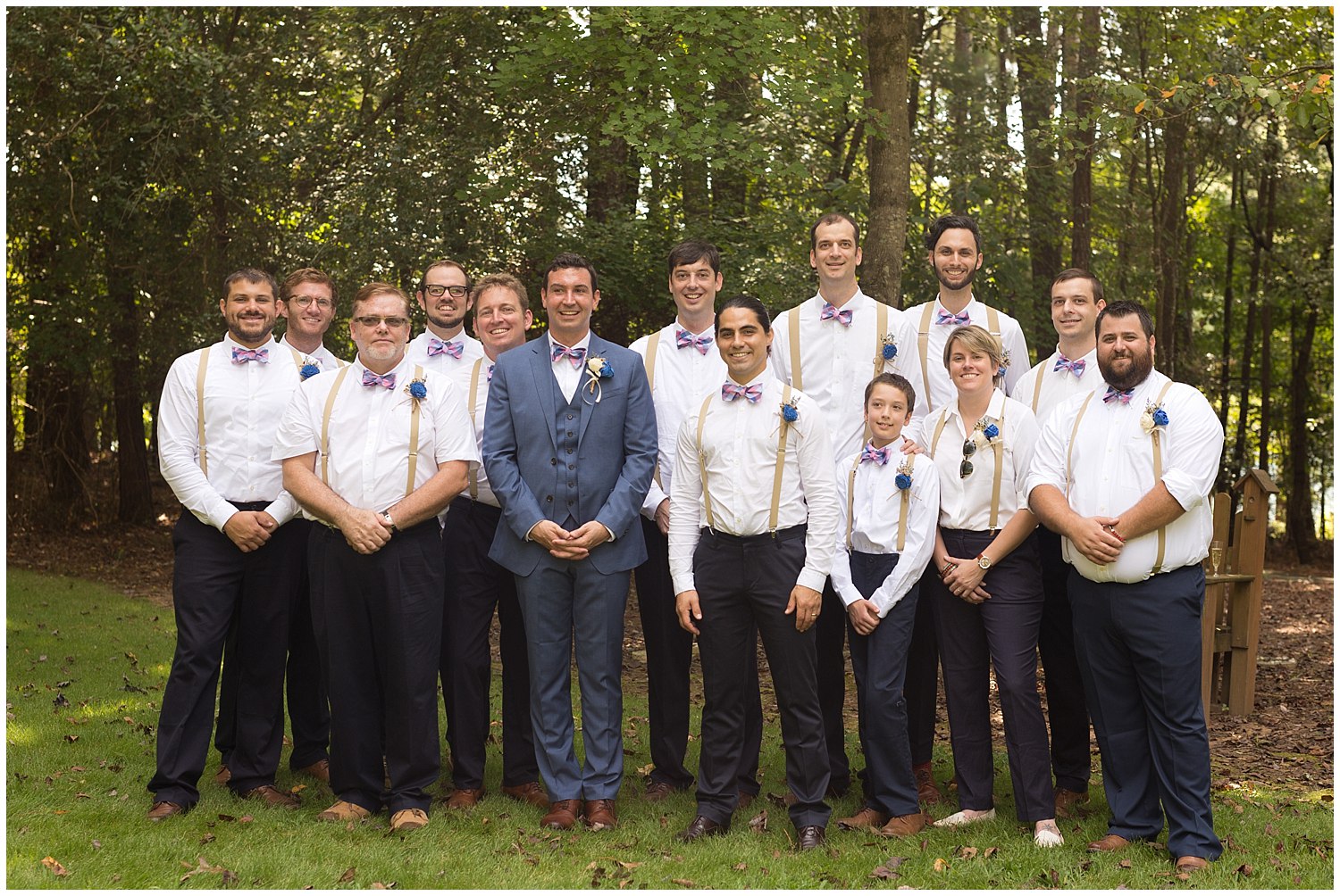 large group of groomsmen with bowties and suspenders