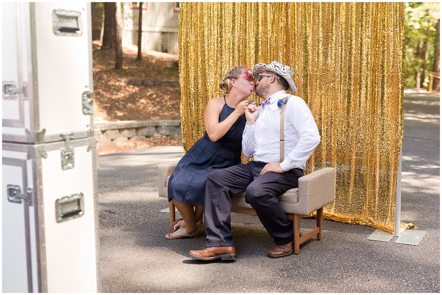 couple being funny in wedding photo booth