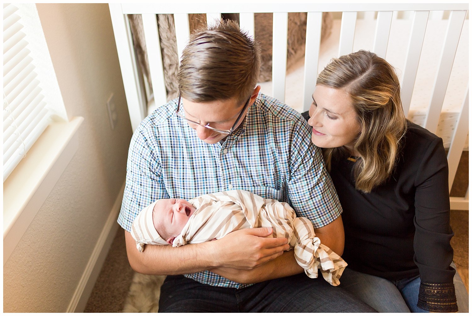 parents with new baby boy in nursery - lifestyle photo