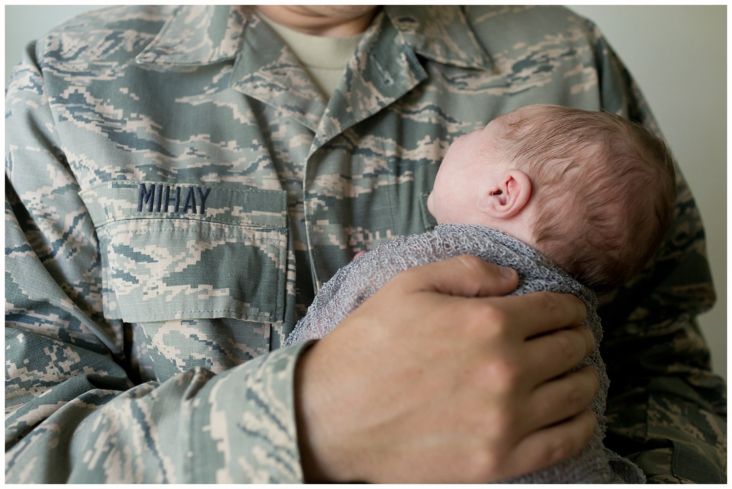 dad holding baby in USAF uniform