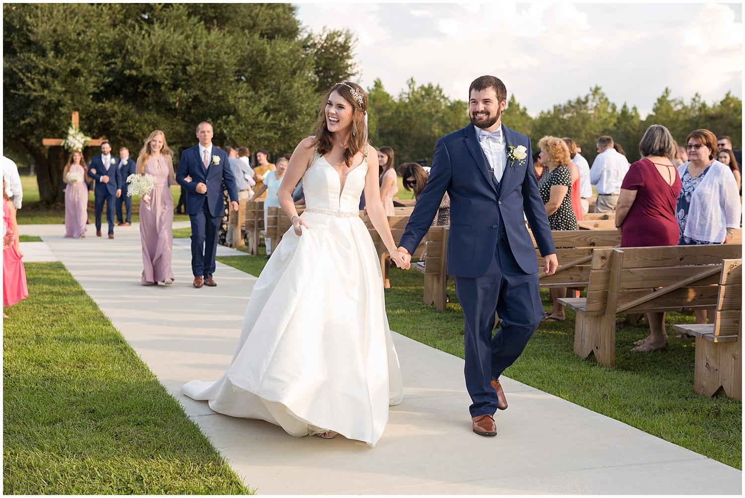 bride and groom walking up aisle after wedding at The Barn at Love Farms