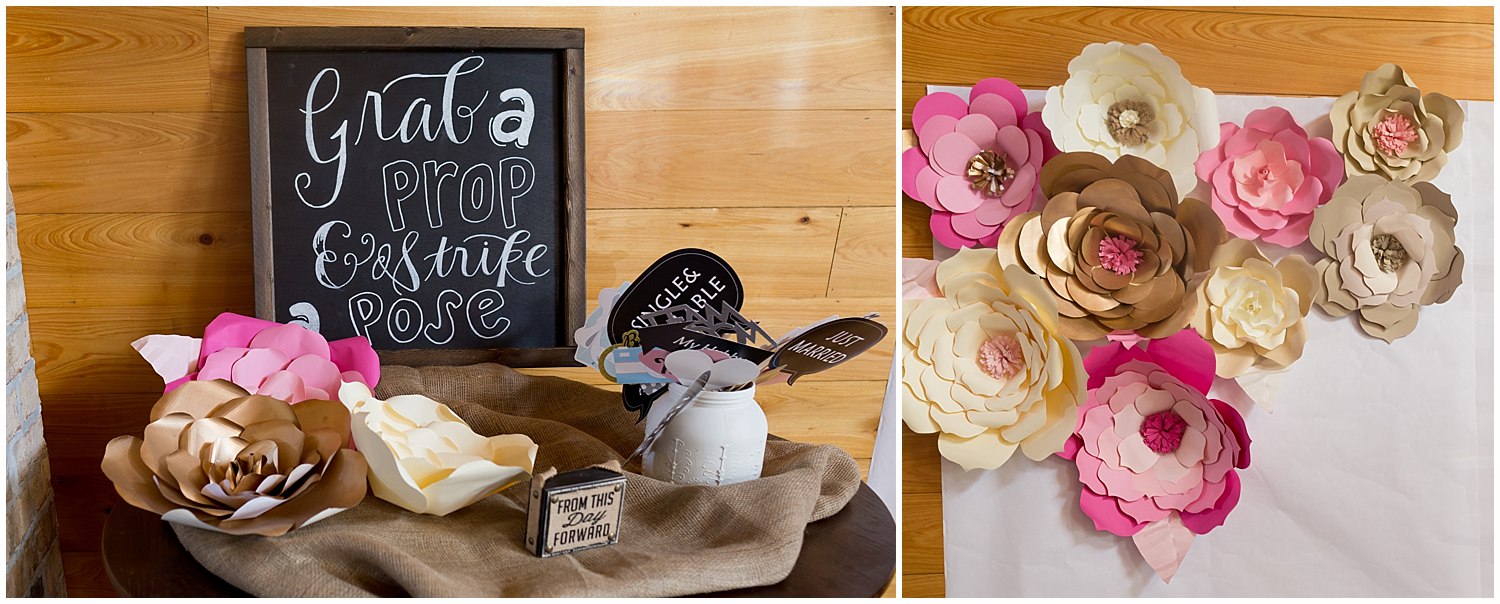 wedding photo booth with chalkboard sign, props, and paper flowers