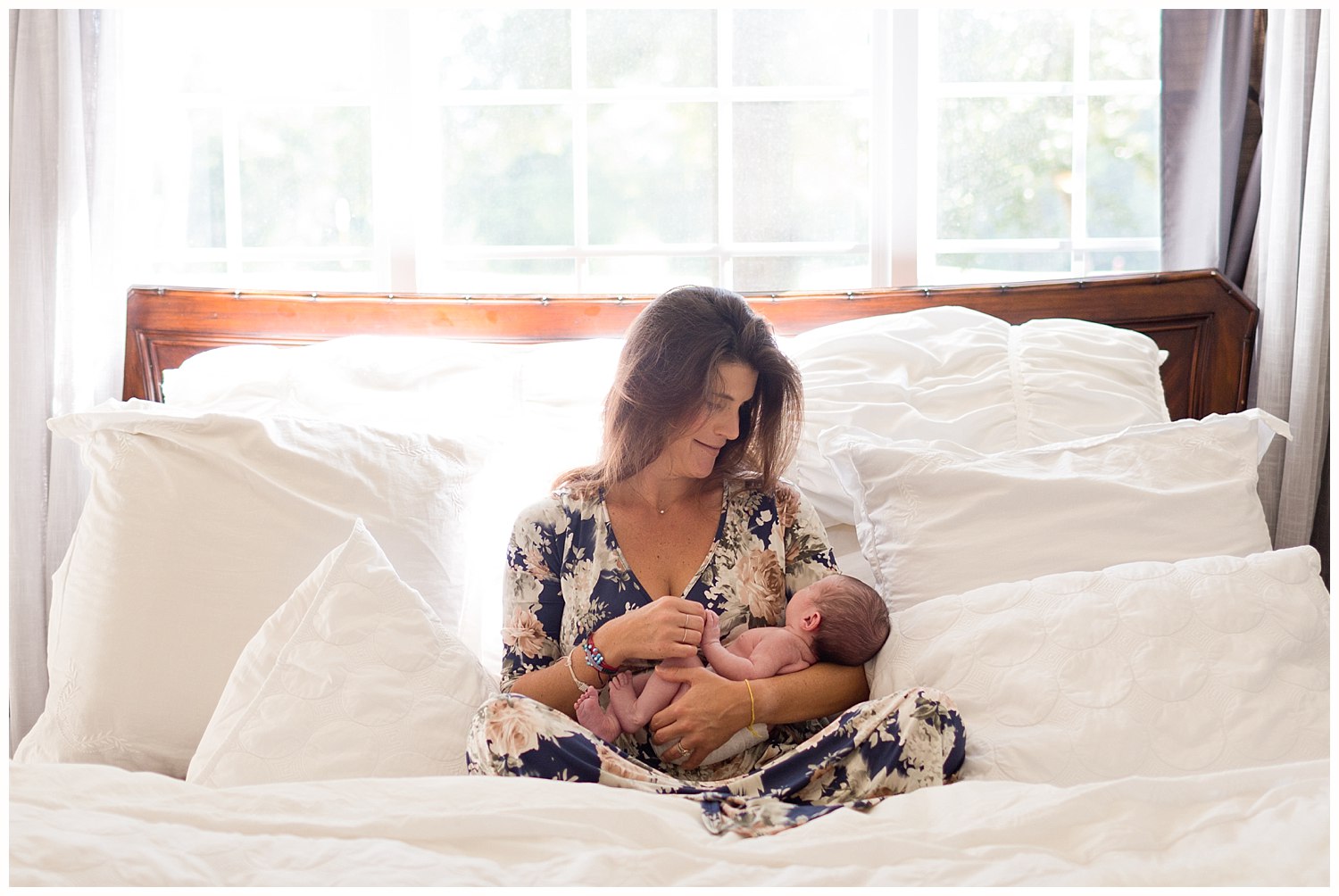 Ocean Springs newborn photographer - lifestyle photo with mom and baby girl on bed