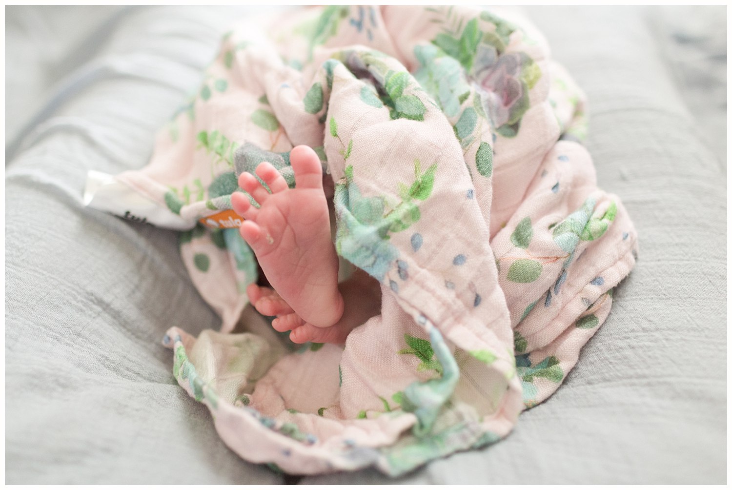 newborn baby toes with flower swaddle blanket - Ocean Springs, MS