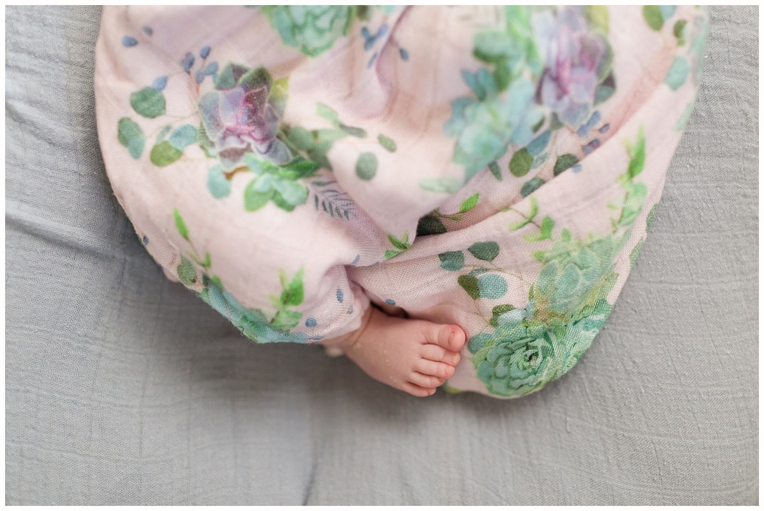 sweet little baby foot sticking out of floral swaddle blanket - Ocean Springs photographer