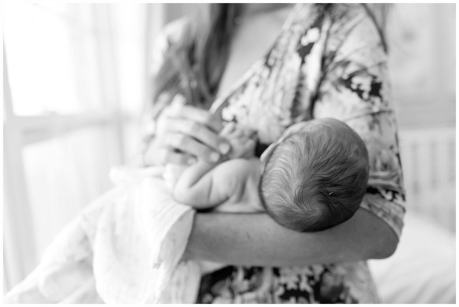 sweet photo of mom cradling newborn baby girl - black and white photo - Ocean Springs photographer