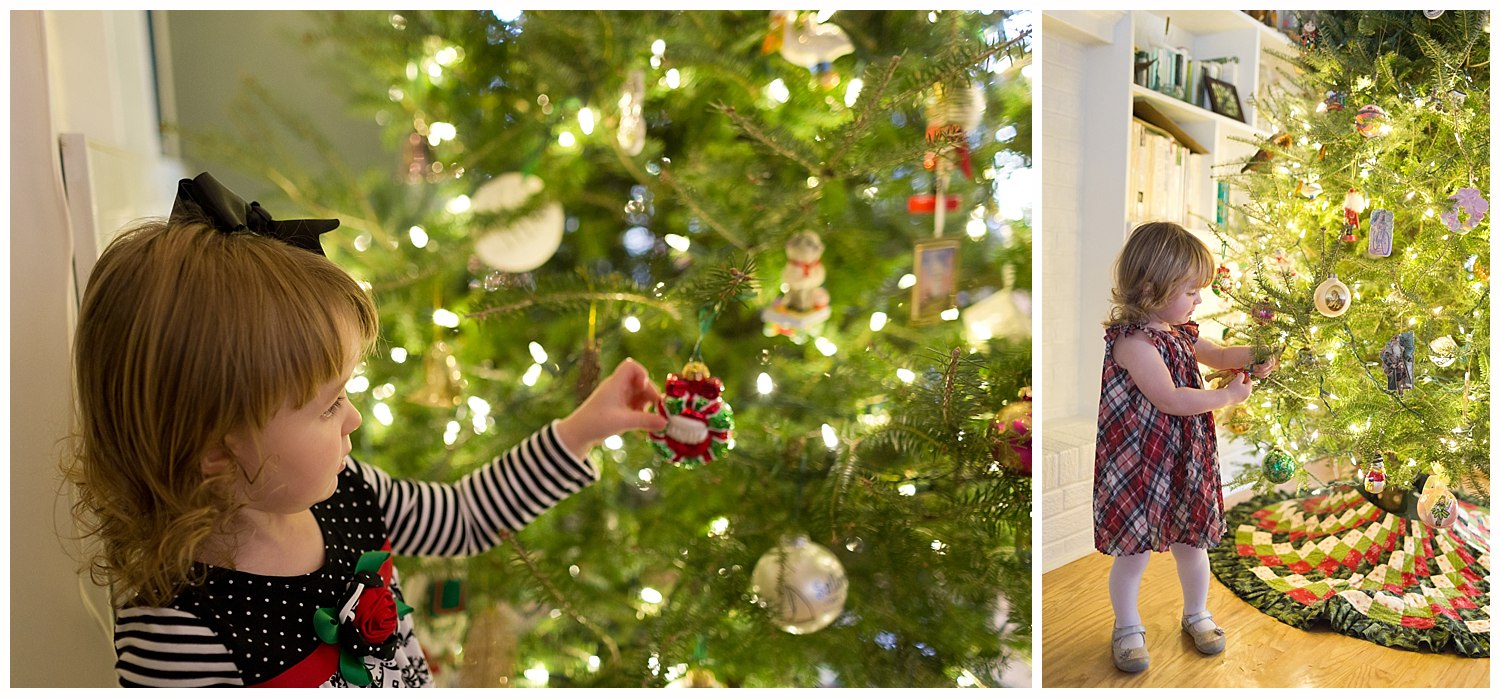 toddler girl playing with Christmas ornaments on tree