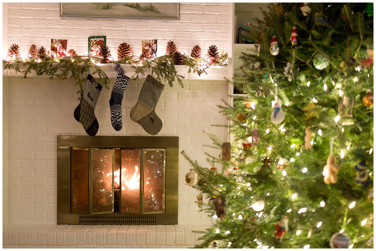 stockings on mantel with fire in fireplace and Christmas tree