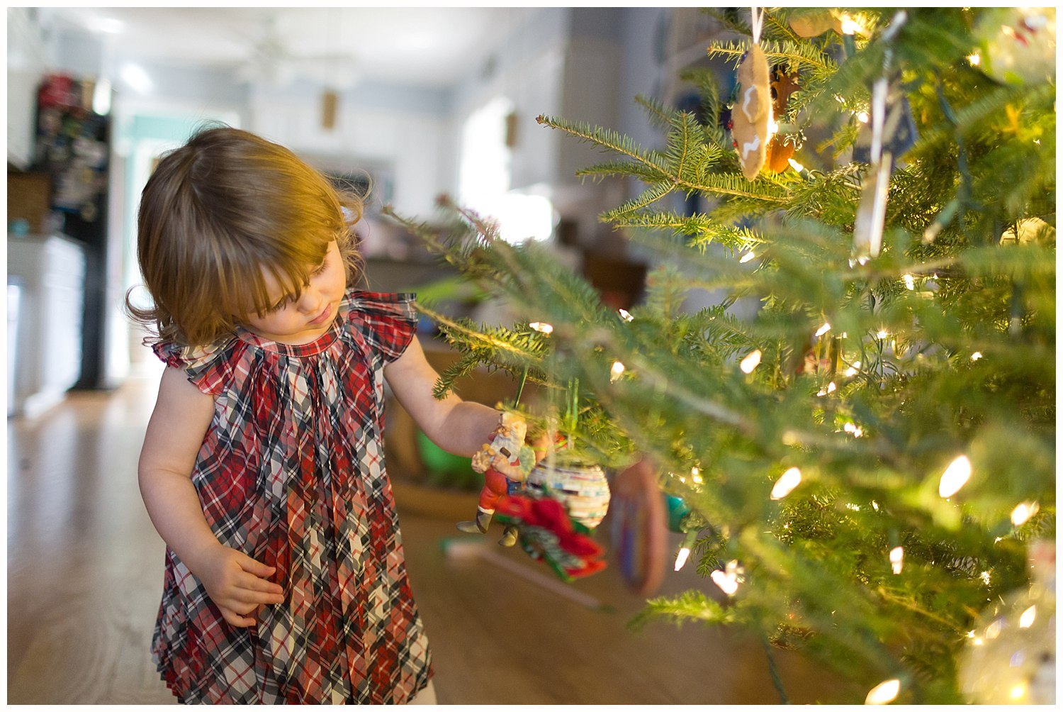 little girl decorating Christmas tree - Ocean Springs lifestyle photographer