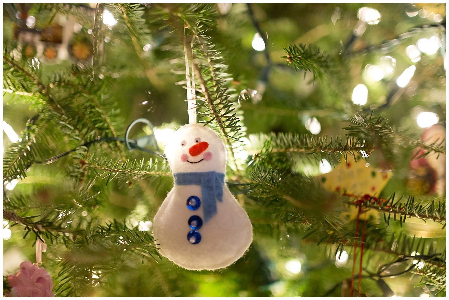 snowman Christmas ornament on tree