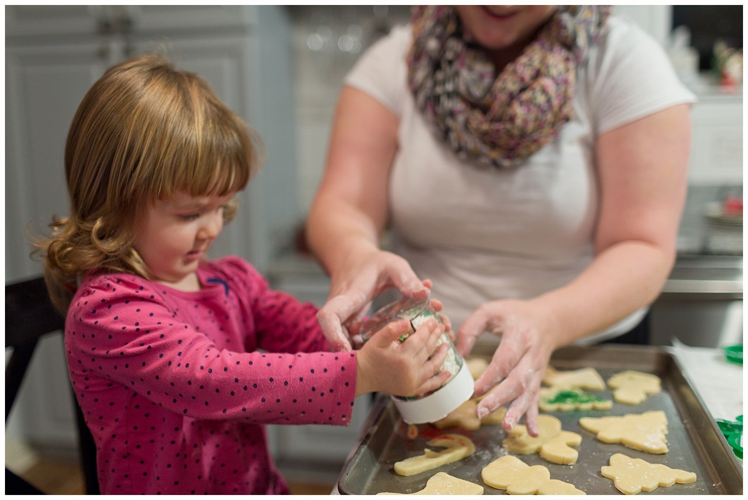 toddler girl decorating Christmas cookies