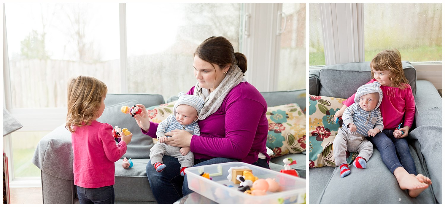 toddler girl playing with infant baby boy