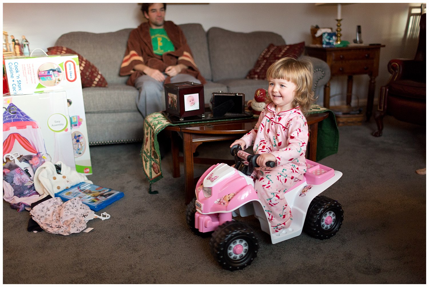 toddler girl with new toys on Christmas morning