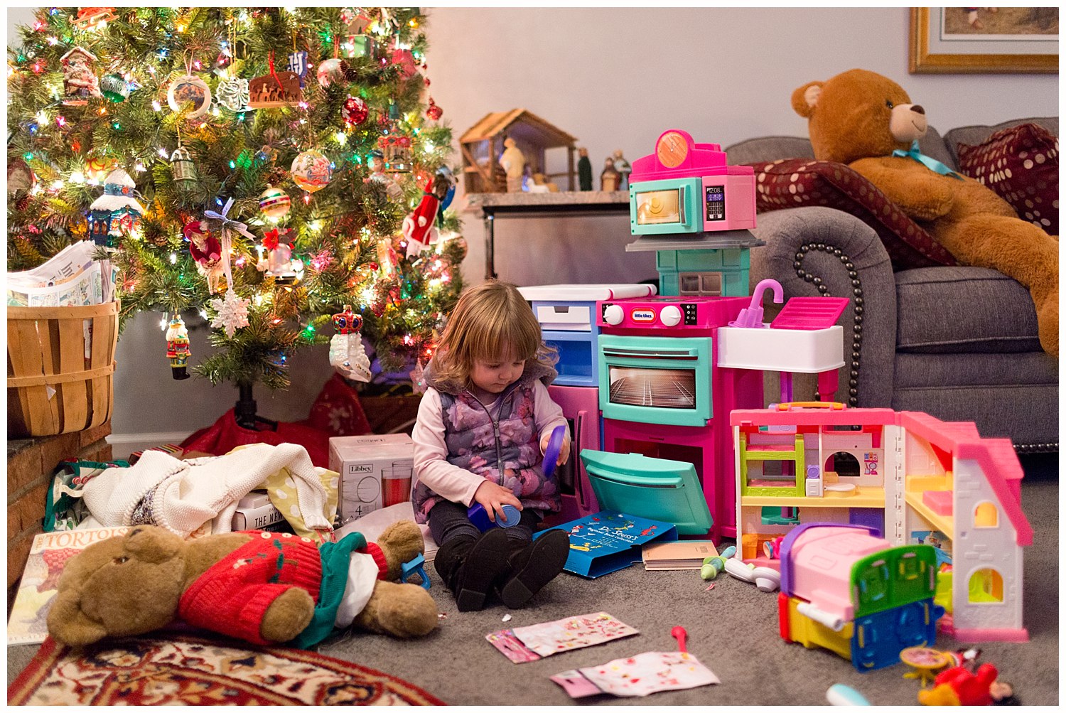 little girl playing with new Christmas toys
