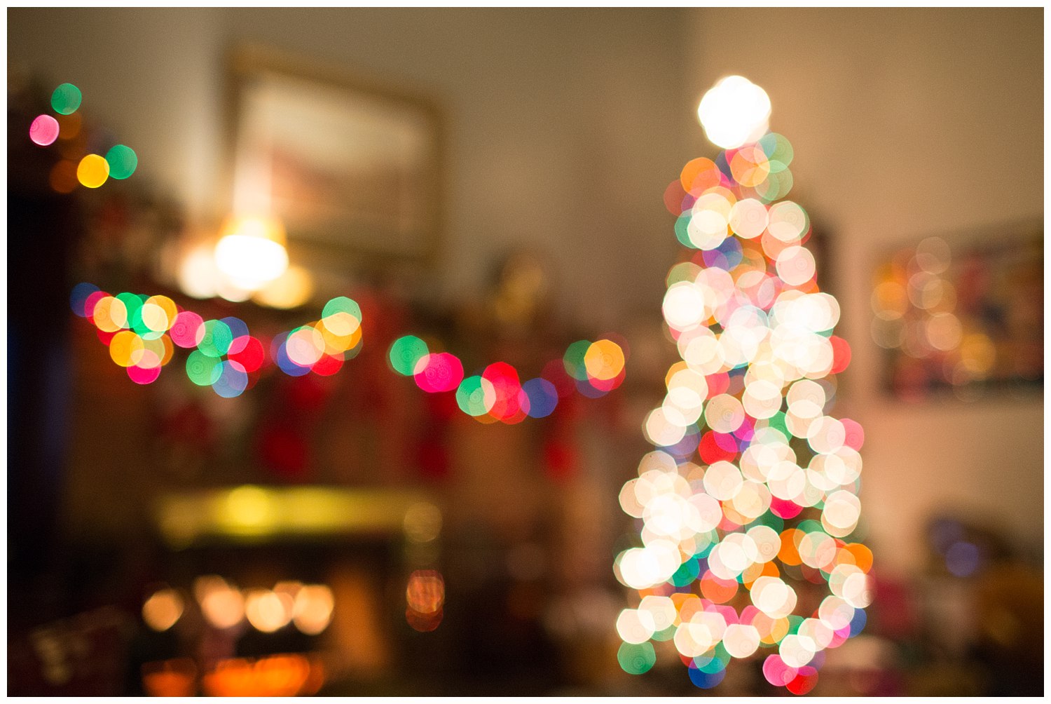 colorful Christmas lights on tree and fireplace mantel