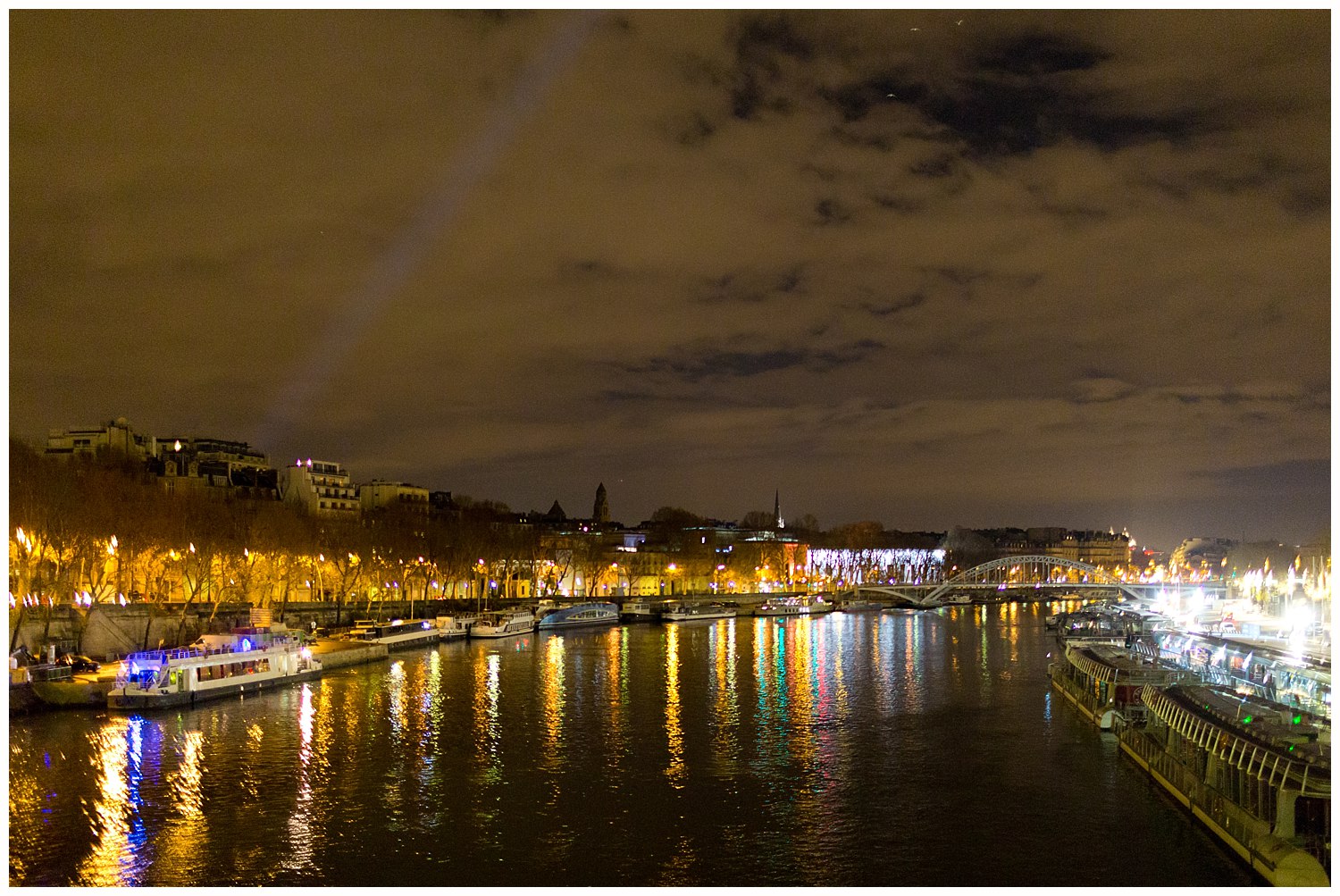view from bridge over river Seine in Paris at night